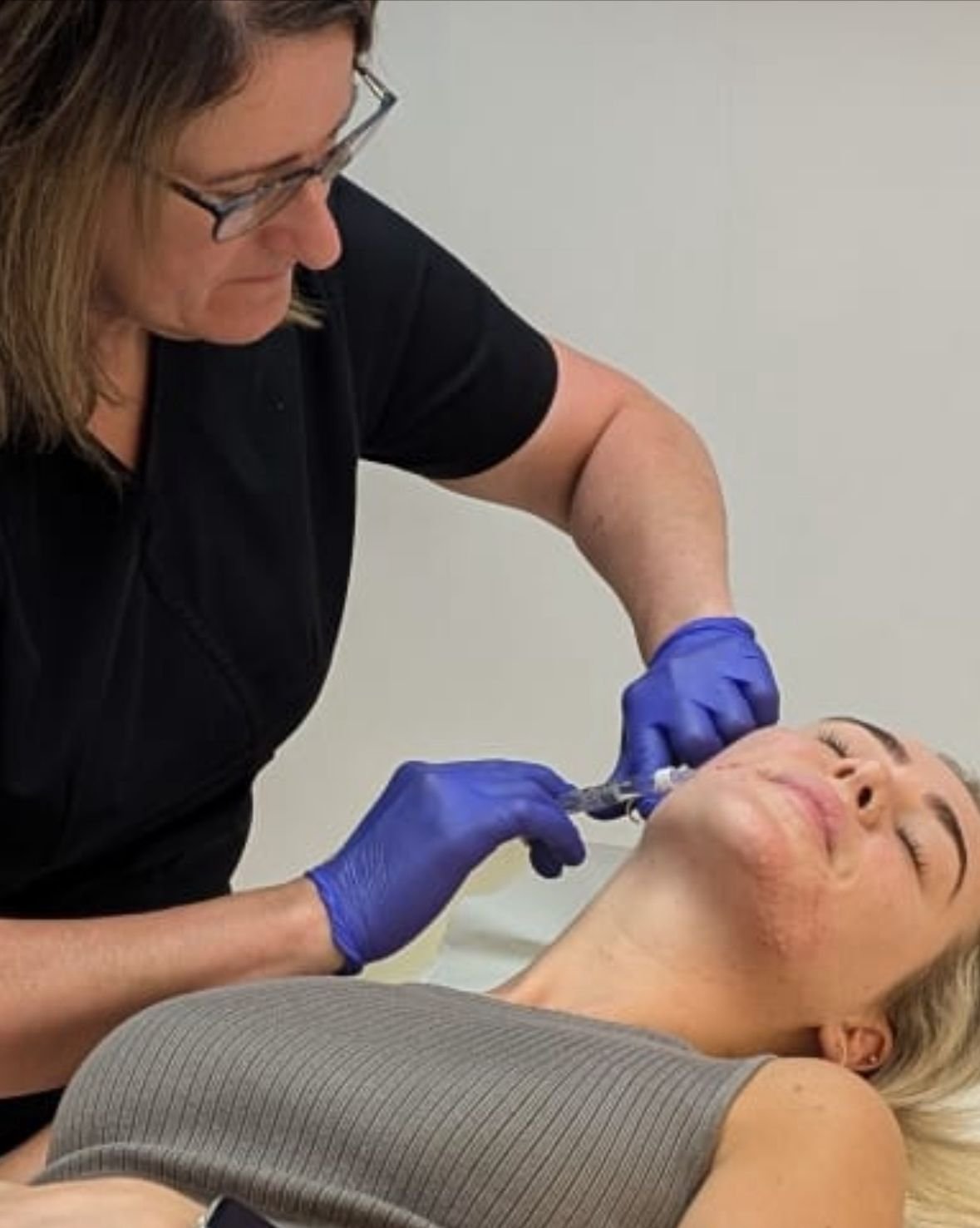 Adele, registered nurse at AC Nurse Aesthetics, performing an aesthetic treatment on a client in Morley, Leeds